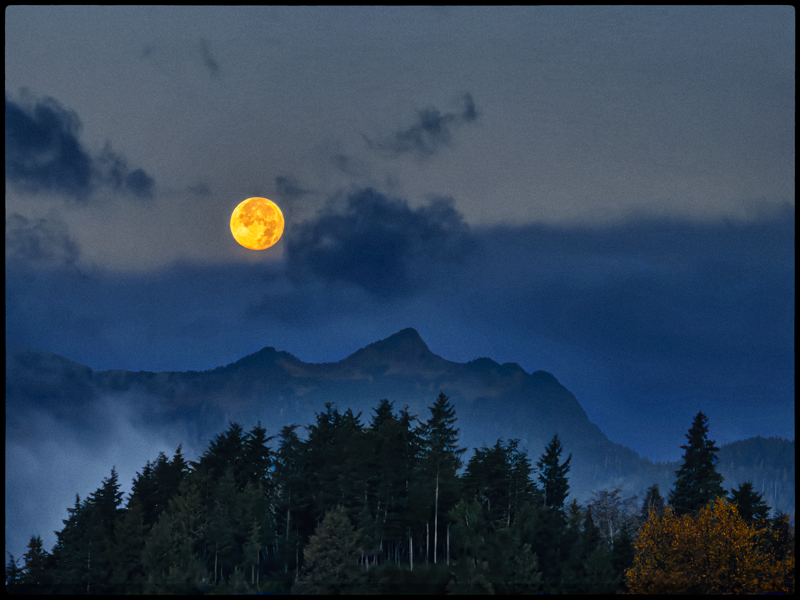 Full moon rising over the mountains
