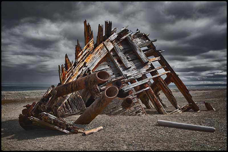 Weathered shipwreck remains on the shoreline