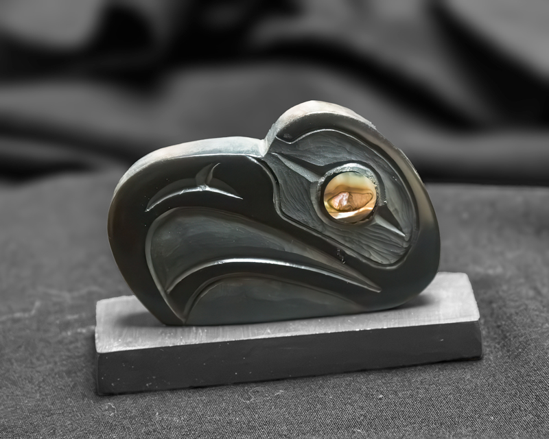 Carved argillite raven head sculpture with abalone inlay